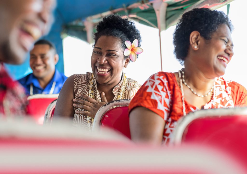 Joyful moments on a bus, where friendly faces and laughter brighten every ride through. Tourism Fiji photo.