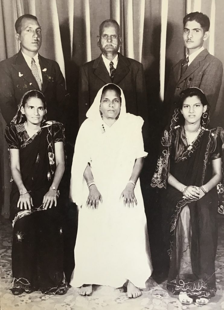 Lali and Sita Maharaj with family. Sita, Ajay’s great-grandmother, is seated in the middle of the front row, with Lali, his great-grandfather, standing behind her.