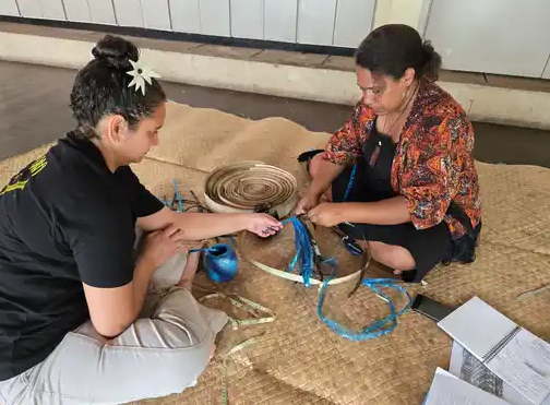 Yasbelle Kerkow (left) and Mere Rasue weaving a liku using natural and synthetic materials at the Fiji Museum, Suva, June 2025. Photo courtesy of The Veiqia Project.