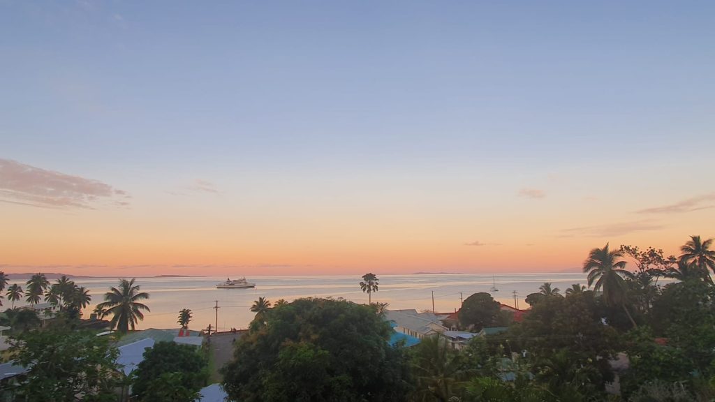 Sunset over Levuka Bay, where calm waters meet the horizon and a ferry glide toward the wharf.
EXPLORE Fiji photo.