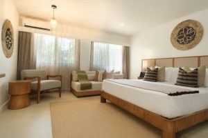 Deluxe King Room at Fiji Gateway Hotel Nadi showing timber tones and woven wall art by Rise Beyond the Reef.