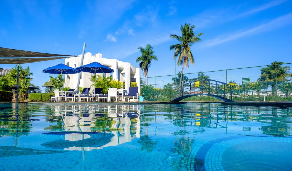 Swimming pool at Fiji Gateway Hotel Nadi with tropical surroundings and blue skies