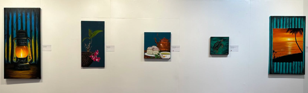 Erica Sing paintings displayed on a gallery wall at the HOME+LAND exhibition in Suva
