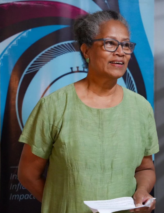 Susie Elliott, guest curator speaking at the opening of the HOME+LAND exhibition as she brings greater visibility to women’s stories through visual arts.